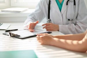 Healthcare provider talking to patient about insurance coverage.